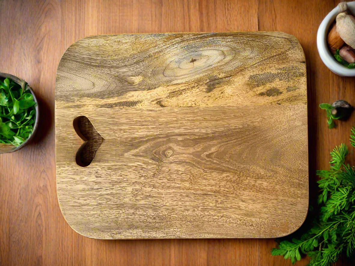 Mango wood chopping boards with cut out hearts. Single board shown.