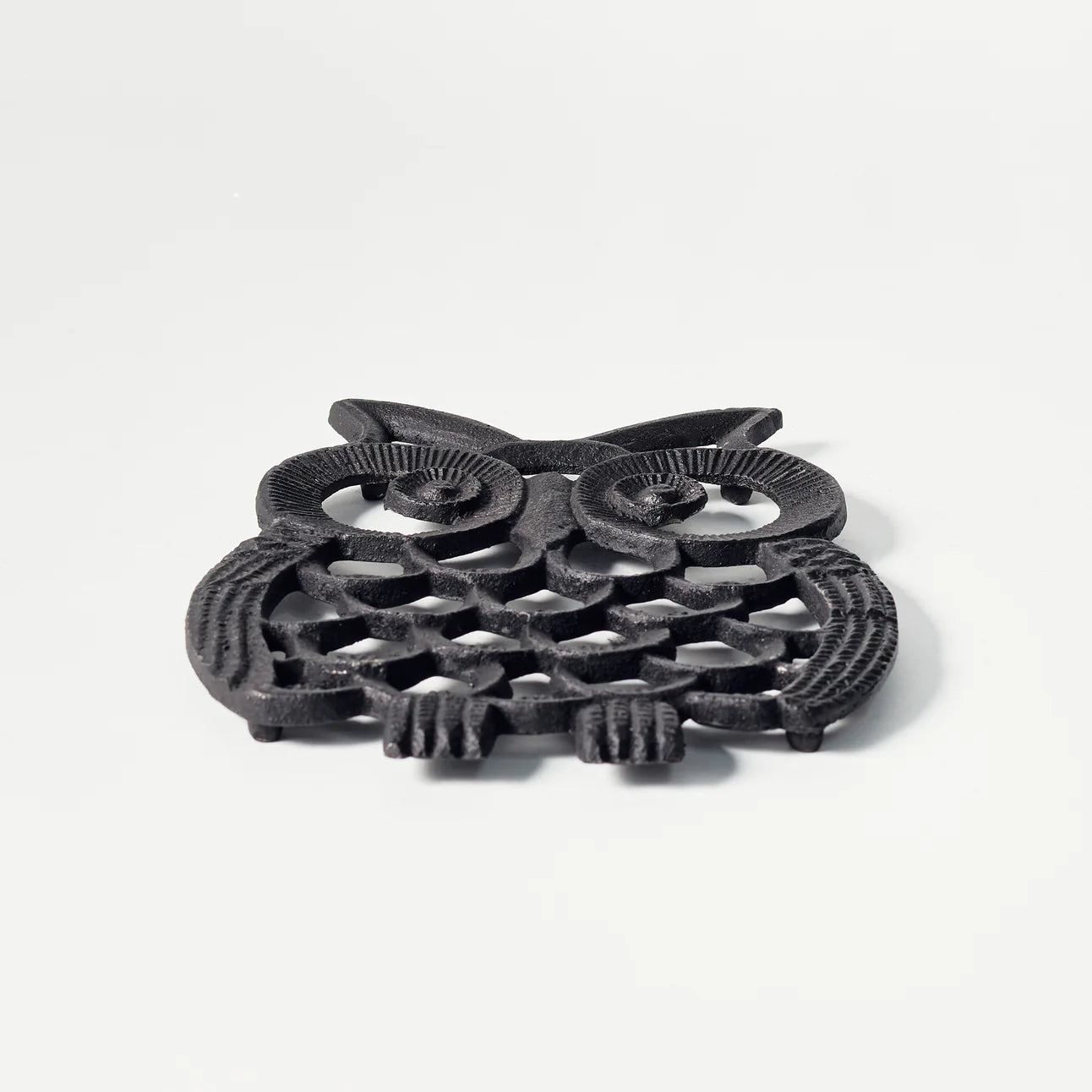 Black painted cast iron OWL design trivet / hotplate - view on the table