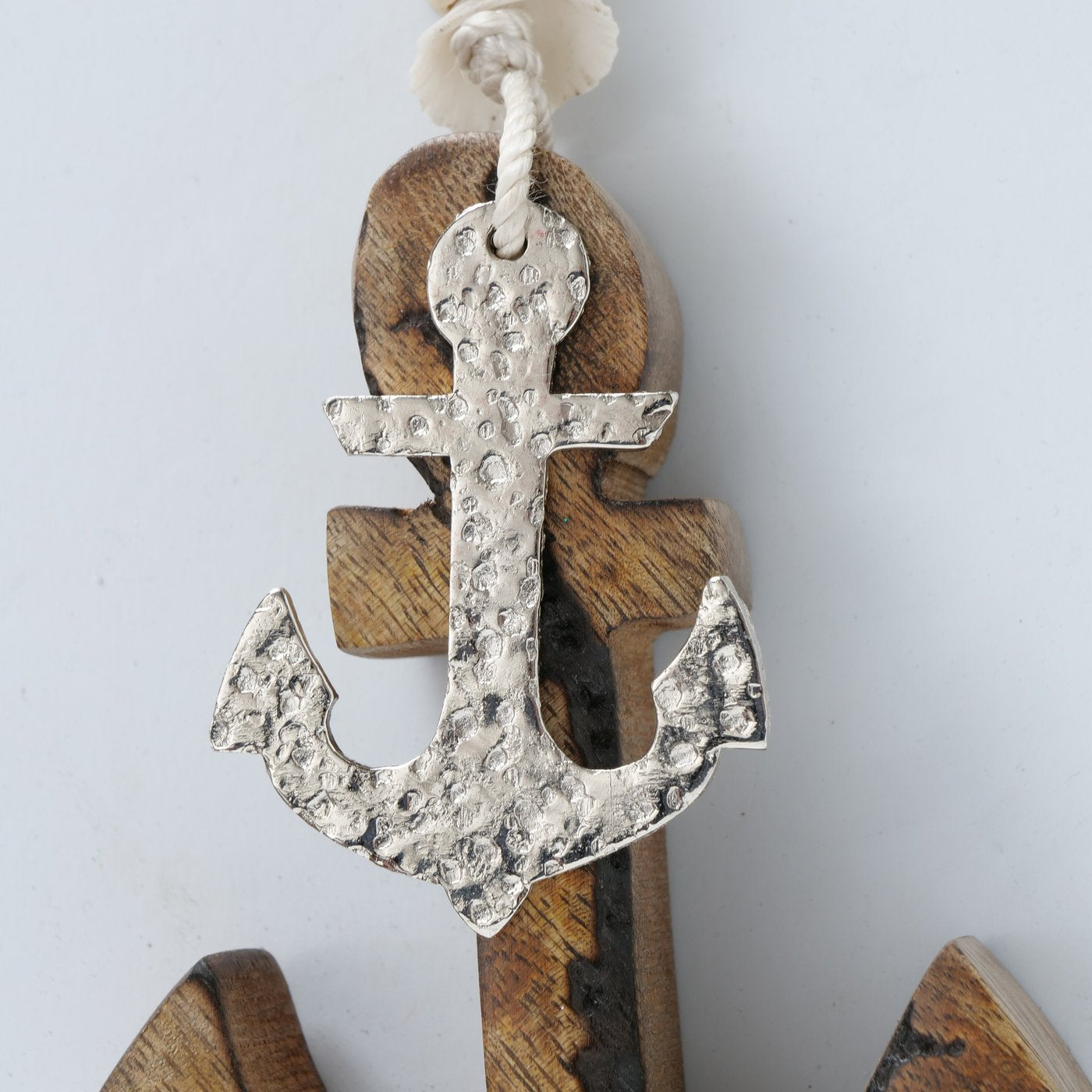 Set of 2 decorative hanging Mango Wood anchors. Close up of white anchor.