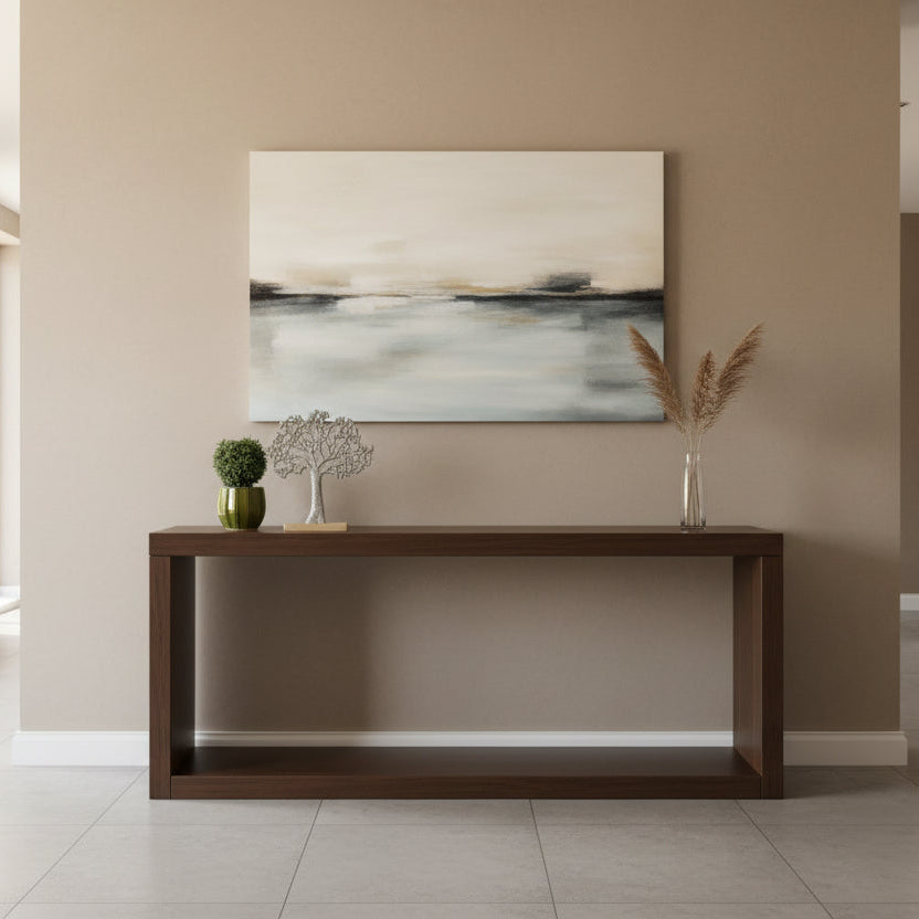 Decorative metal tree sculpture on a wooden base next to a potted plant on a shelf.
