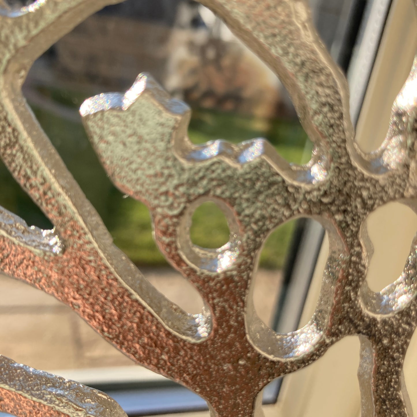 Tree of Life ornament on Mango wood plinth - close up shot.