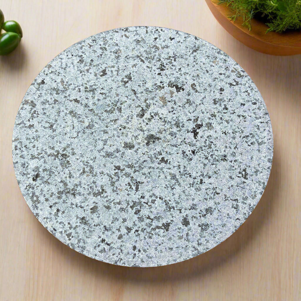 Round grey stone coaster on a wooden surface