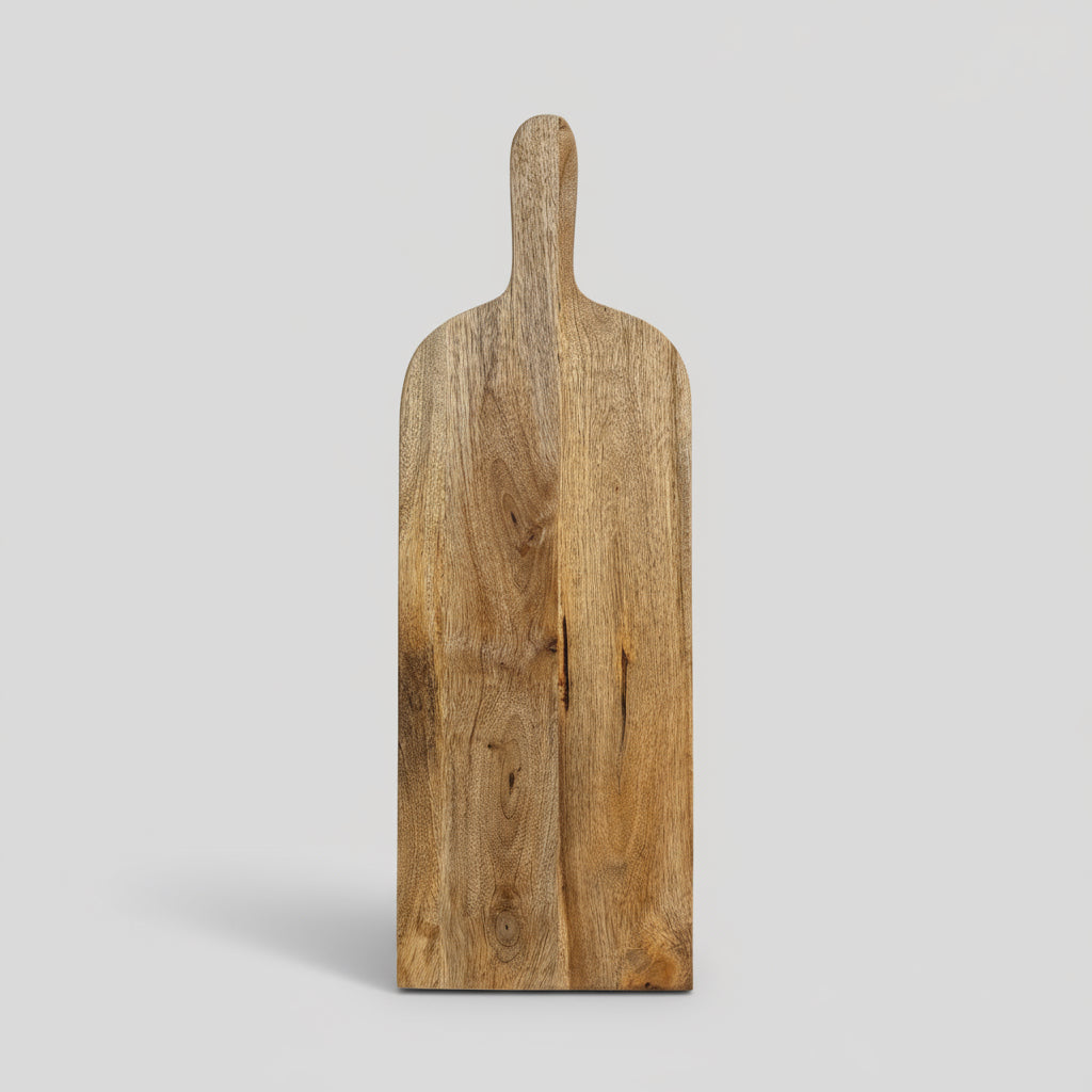 Wooden paddle on a wooden surface with a white paneled wall background