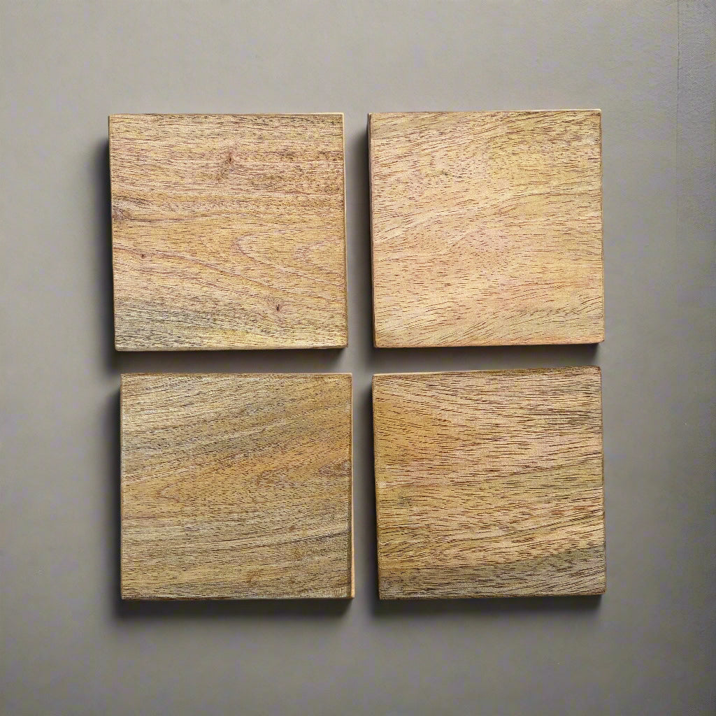Four square wooden tiles on a grey wooden surface