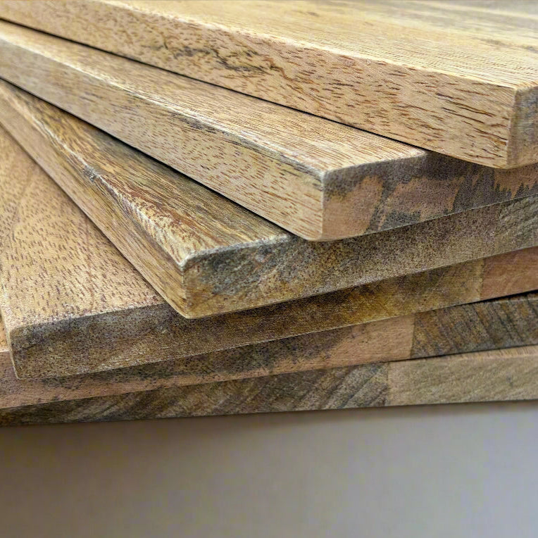 Stack of wooden planks with a natural finish on a neutral background