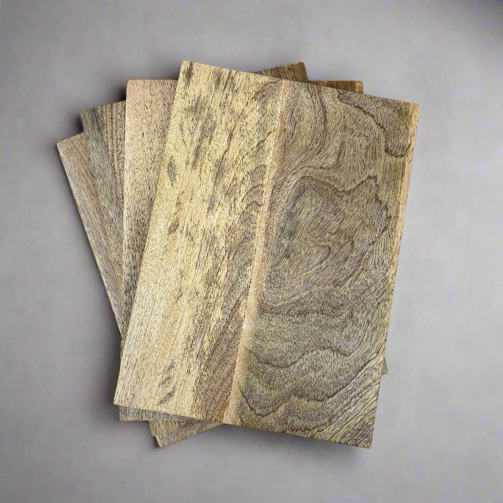 Four mango wood boards with a wood grain pattern on a grey background