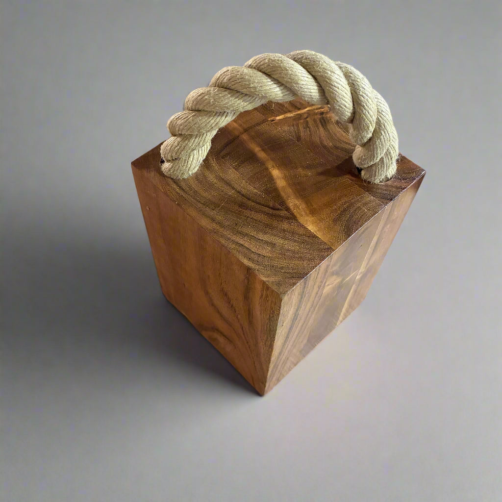 Wooden block with a knotted rope on a wooden surface