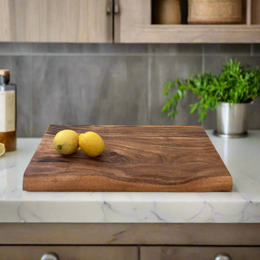 Solid Handmade Acacia Thick Chopping Board with Hand Grooves on a counter top.