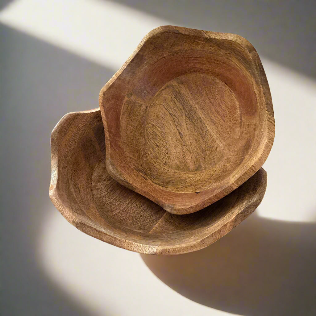 Stack of wooden bowls on a wooden floor
