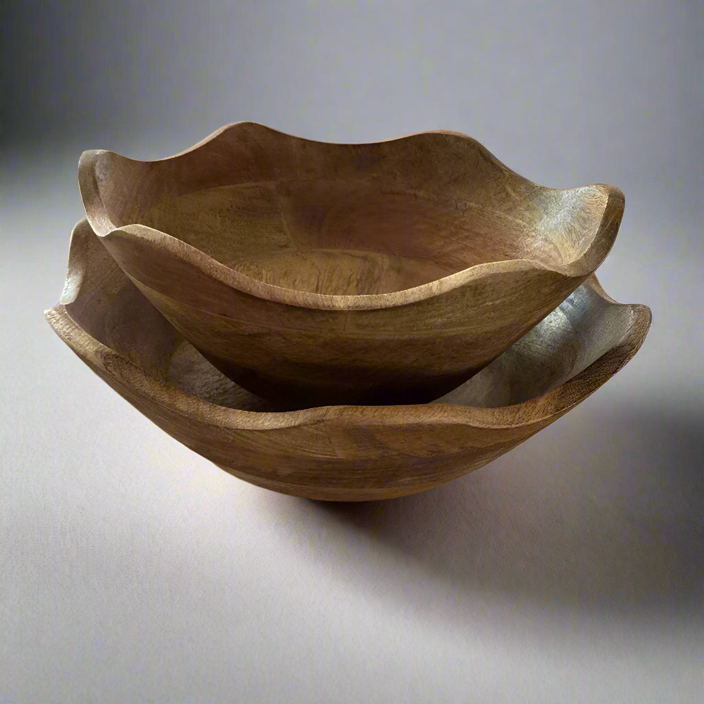 Two wooden bowls stacked on a gray surface