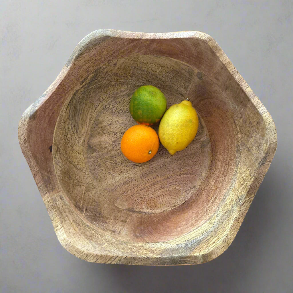 Wooden bowl with fruits on a wooden surface