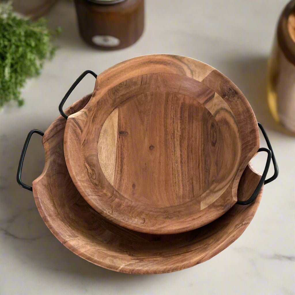 Wooden serving bowl with handles on a kitchen counter