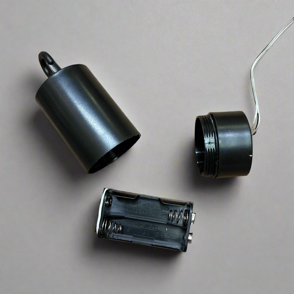 Three black cylindrical objects on a brown surface