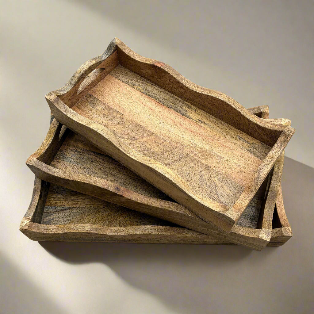 Stack of wooden trays on a wooden floor