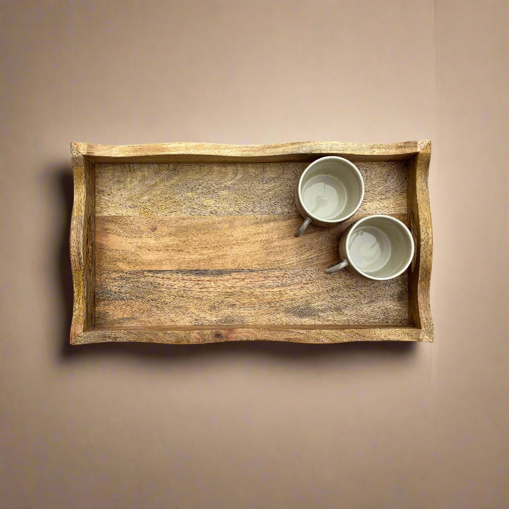 Wooden tray with two white cups on a wooden floor