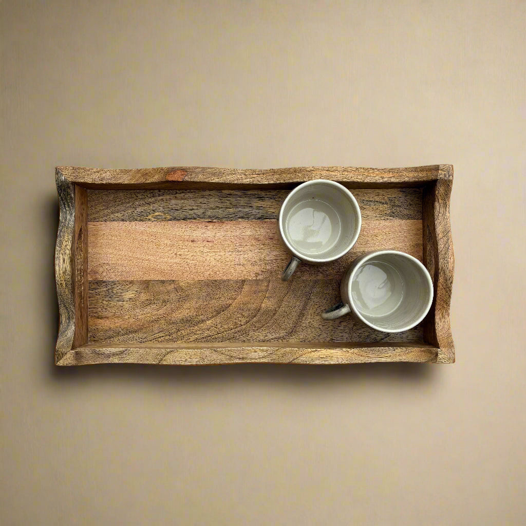 Wooden tray with two ceramic cups on a wooden surface