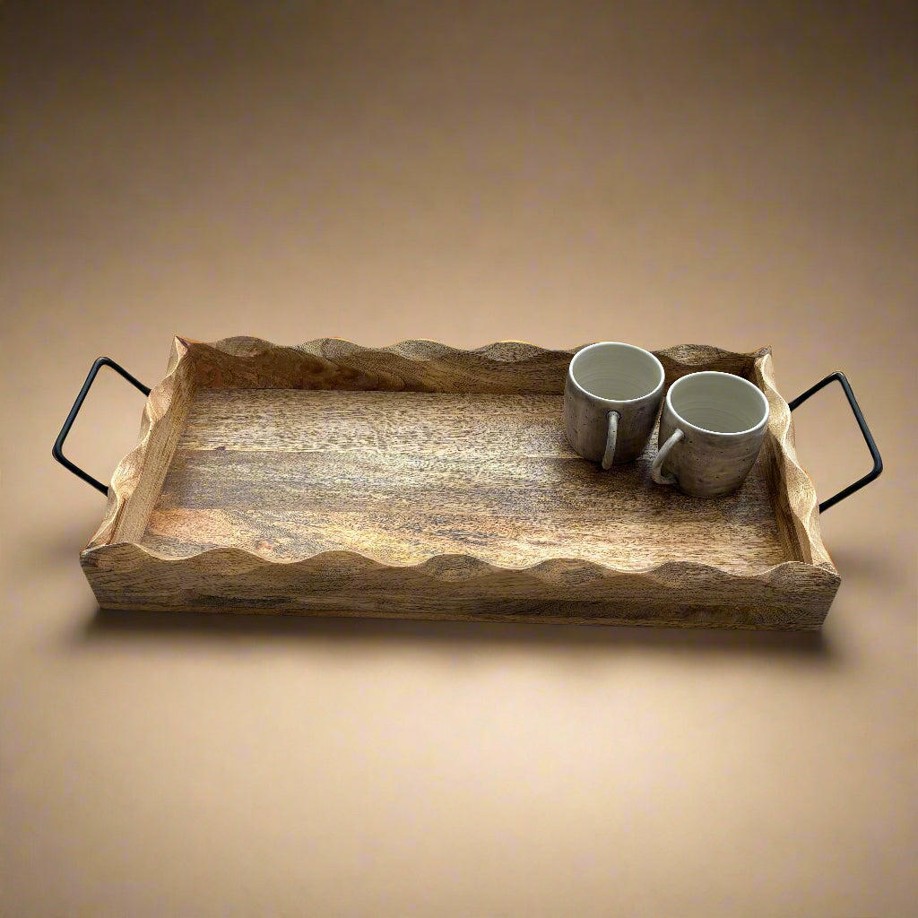 Wooden tray with two mugs on a gray wooden floor
