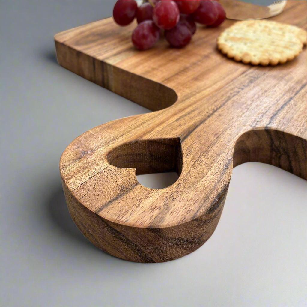 Wooden cutting board with a unique design on a light gray surface.