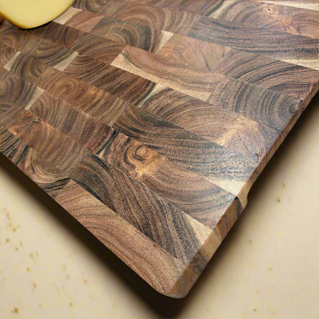 Wooden cutting board with a wavy pattern on a light gray surface