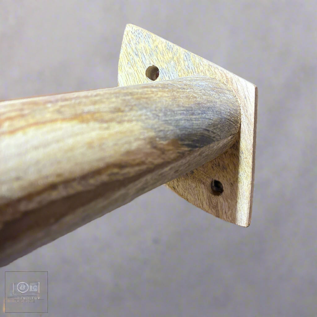 Wooden shelf bracket with a tool in the foreground, set against a warehouse background.