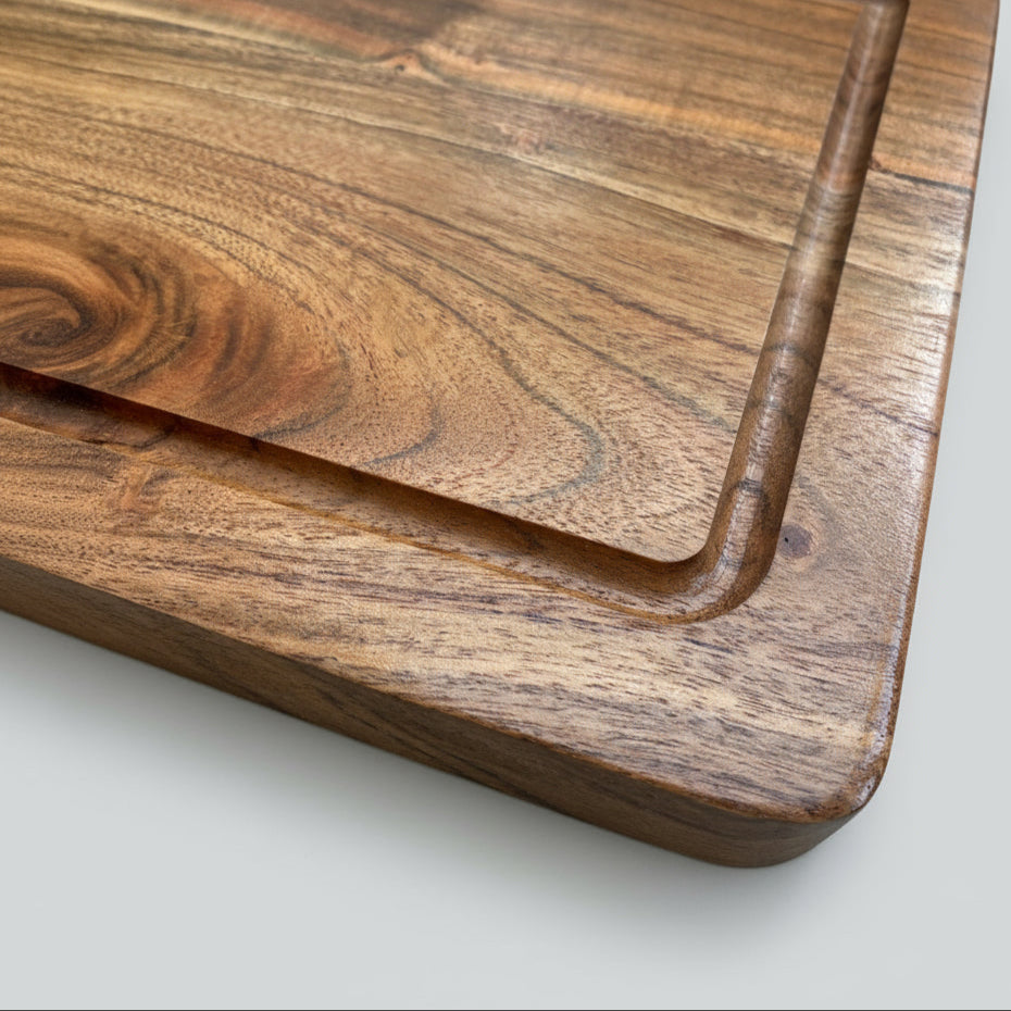 Two wooden cutting boards stacked on a light gray surface