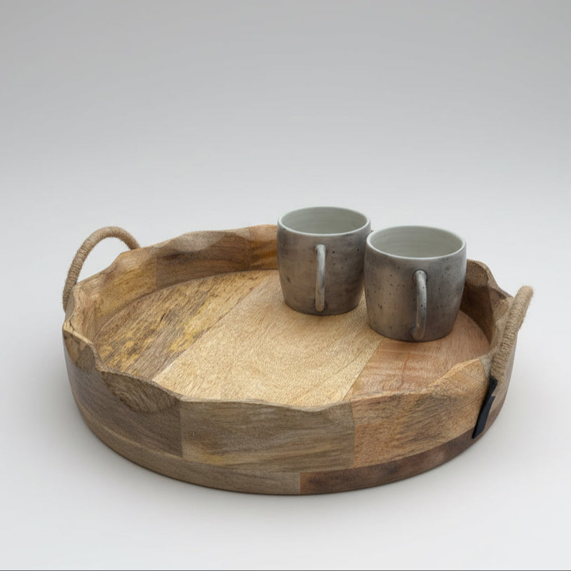 Wooden tray with two ceramic cups on a wooden floor