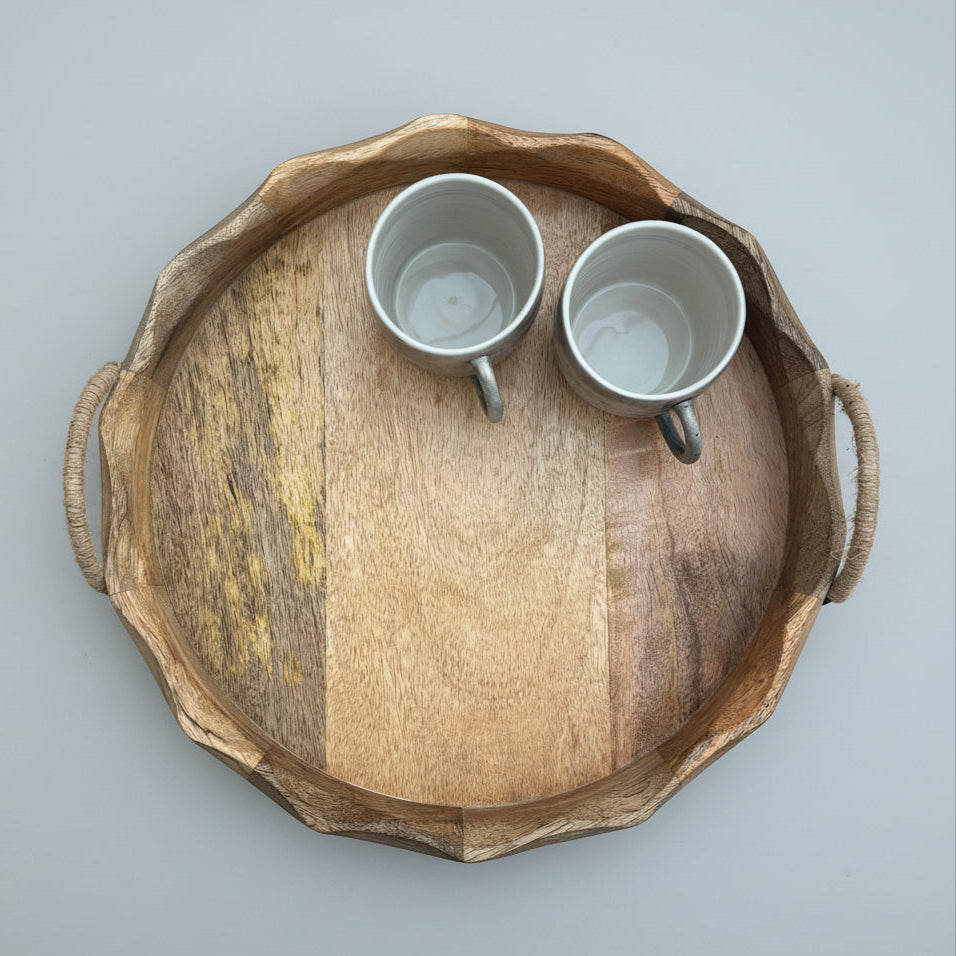 Wooden tray with two ceramic cups on a wooden floor