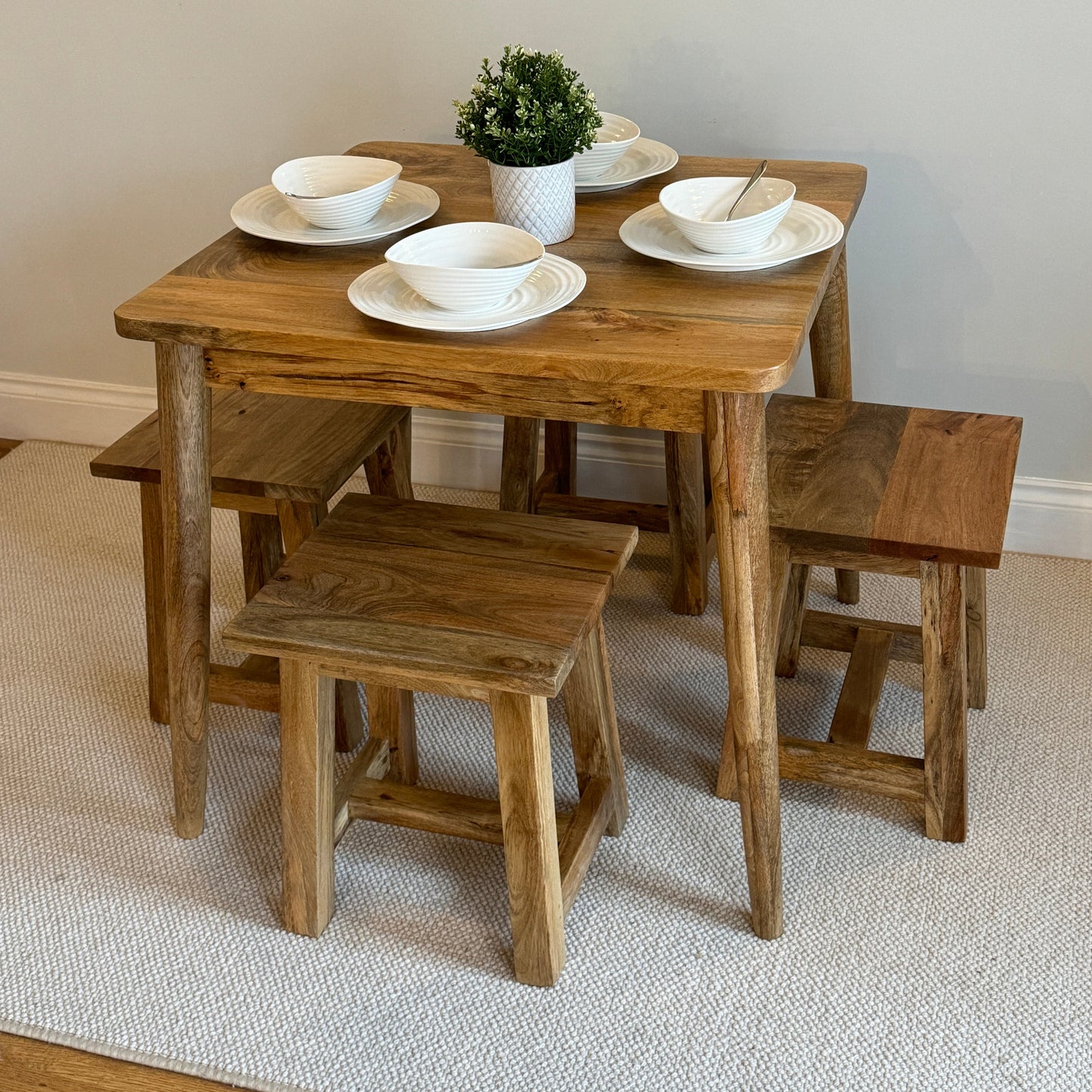 80cm Square Mango dining table with cone shaped legs dressed with 4 settings with 4 stools