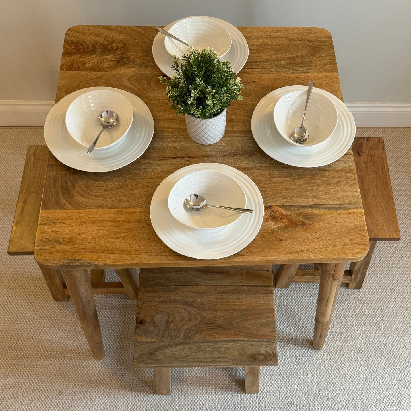 80cm Square Mango dining table with cone shaped legs dressed with 4 settings and stools