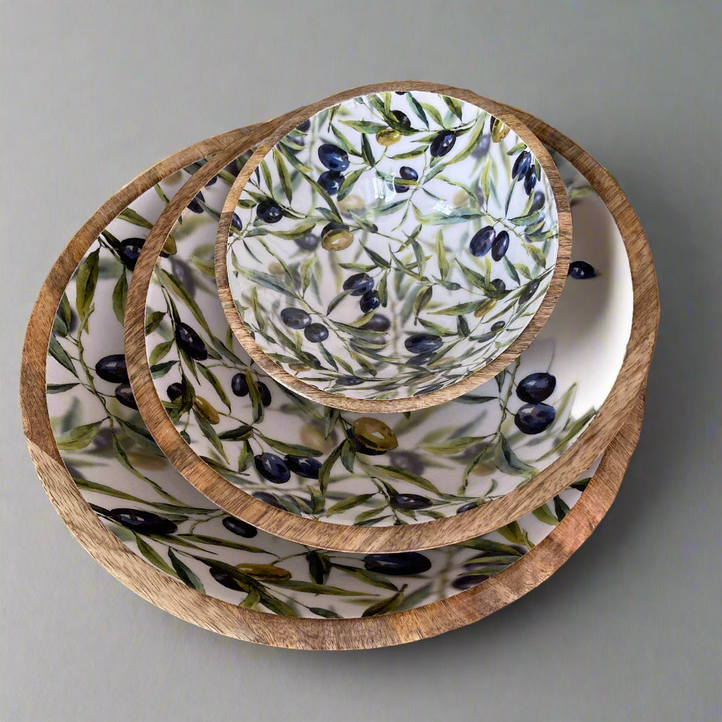 Set of mango wood bowls with enamelled olive design on a gray background