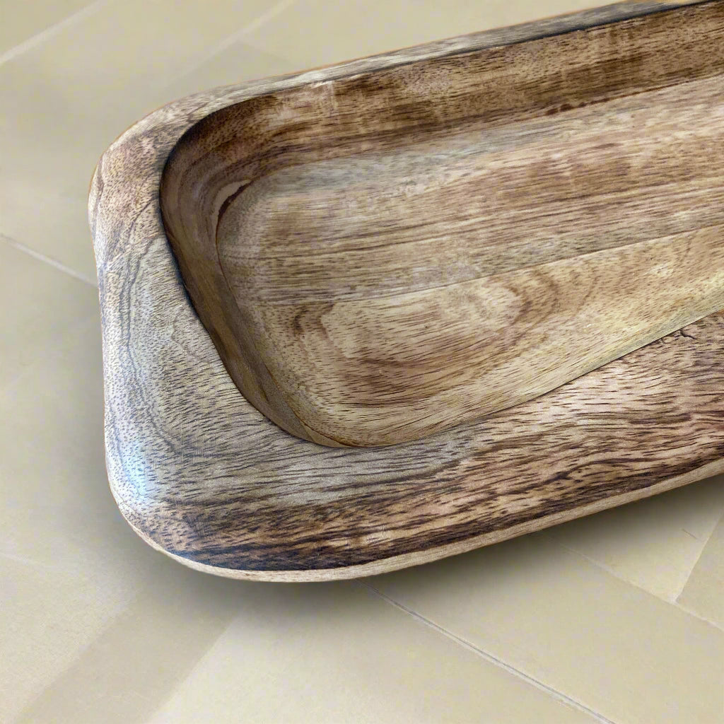 Wooden cutting board with a natural grain pattern on a wooden surface