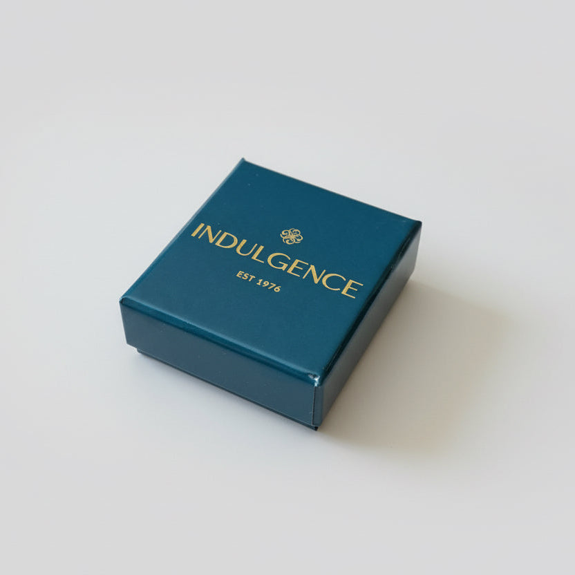 Blue box with 'Indulgence' branding on a textured surface