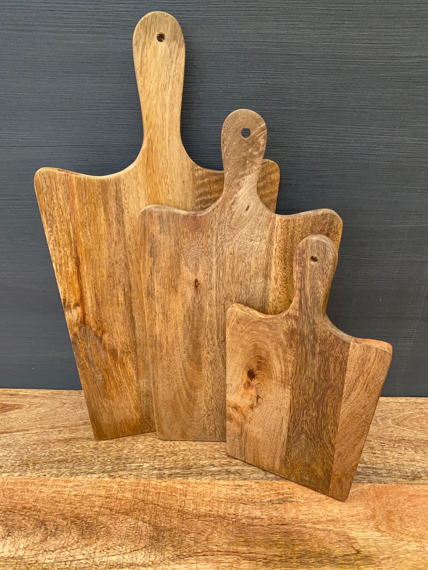Solid Mango wood food serving paddle boards - Available in 3 sizes. Set of three displayed.