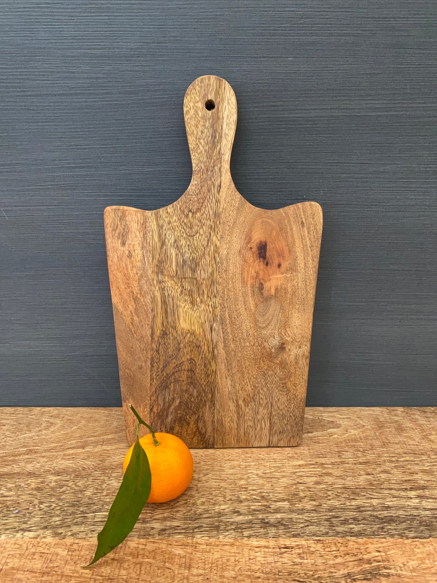 Solid Mango wood food serving paddle boards - Available in 3 sizes. Medium board with orange.