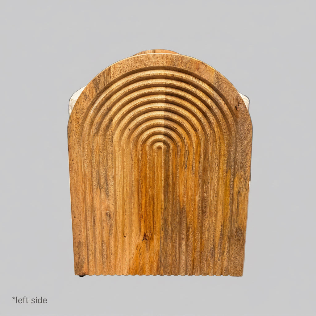 A rectangular wooden panel with a rounded arch top and concentric grooved pattern, photographed indoors on a white sheet in what appears to be a warehouse or workshop setting.