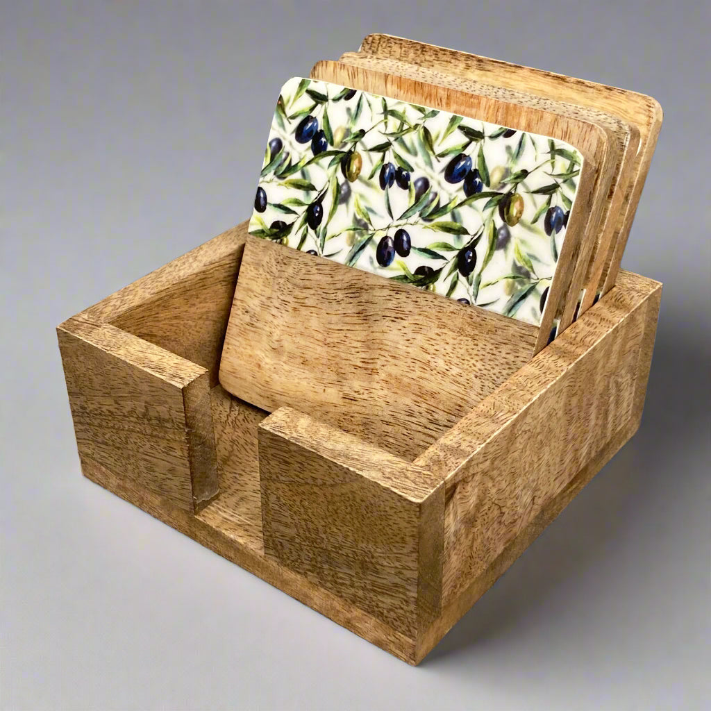 Solid 10cm square Olive Grove design Mango wood coasters in a holder - set of 4. Coasters stood in holder.