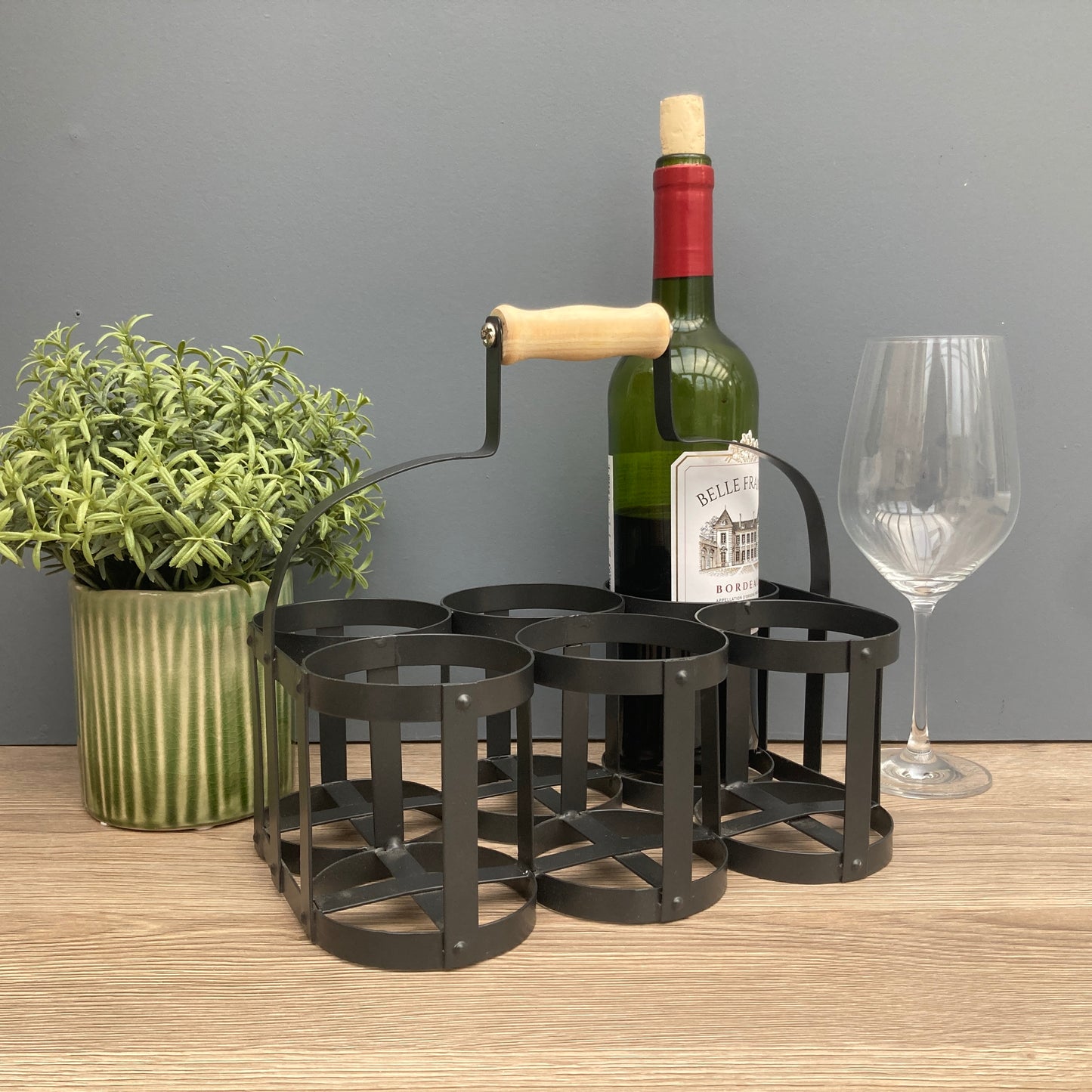 Black steel 6 bottle holder. Ideal for milk basket, wine rack, or condiments. With wine.