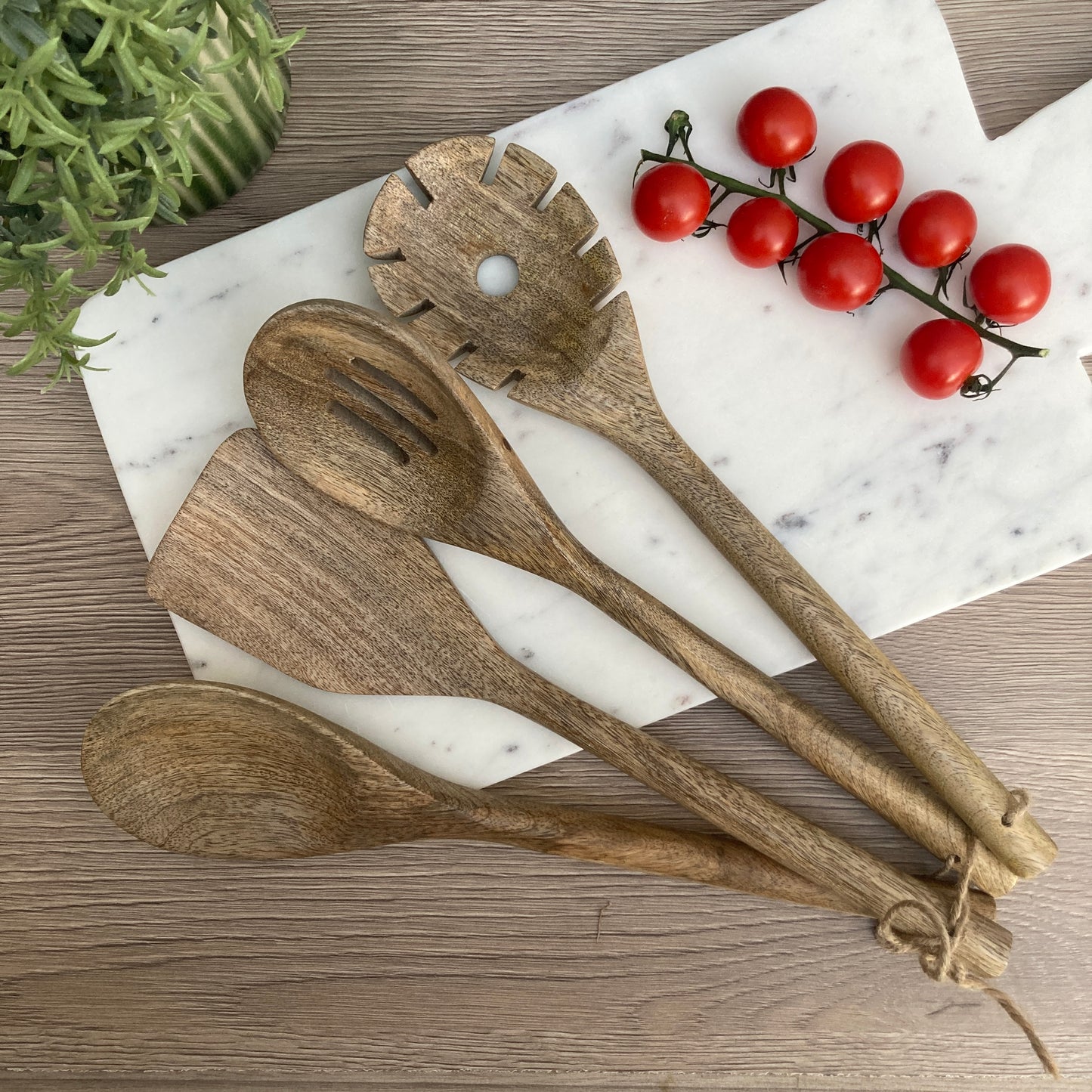 Set of 4 Mango wood kitchen utensils on a counter