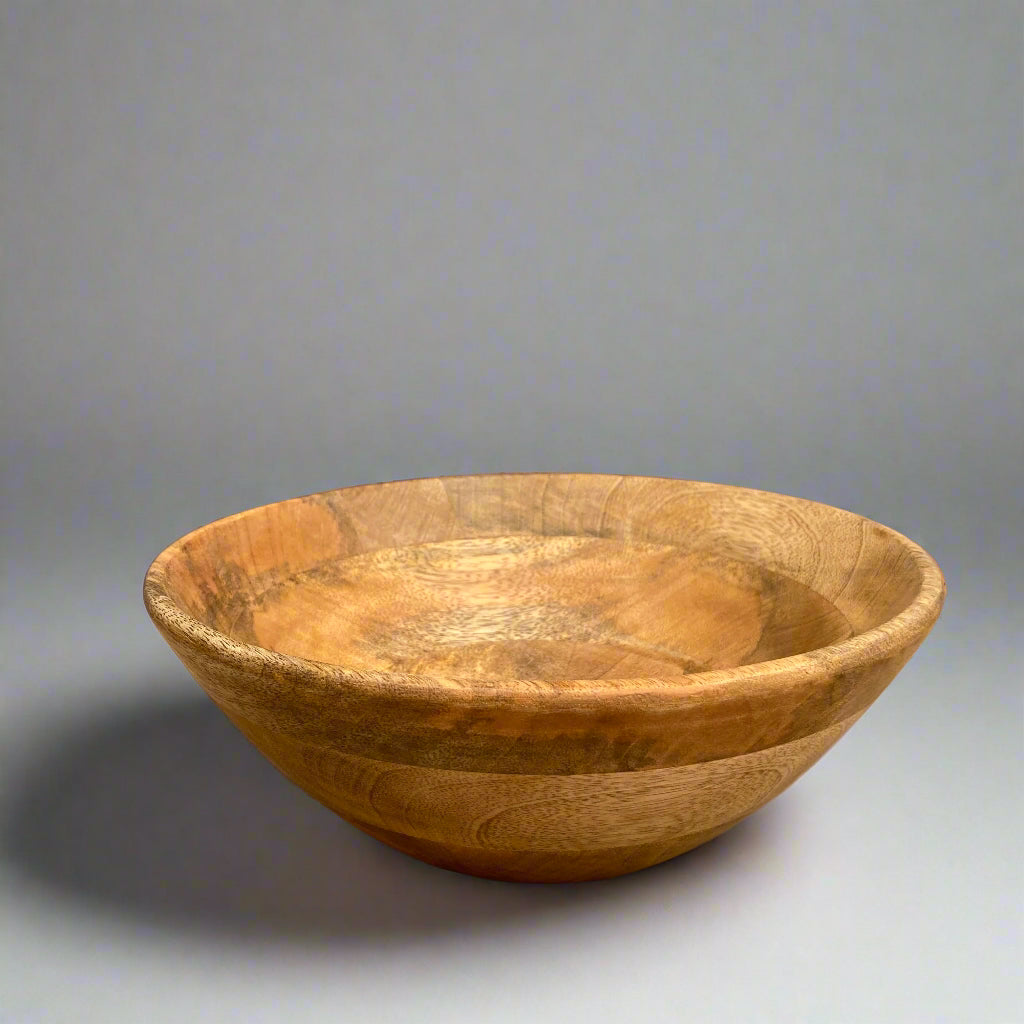 Beautiful Mango wood bowl with a plain grey background