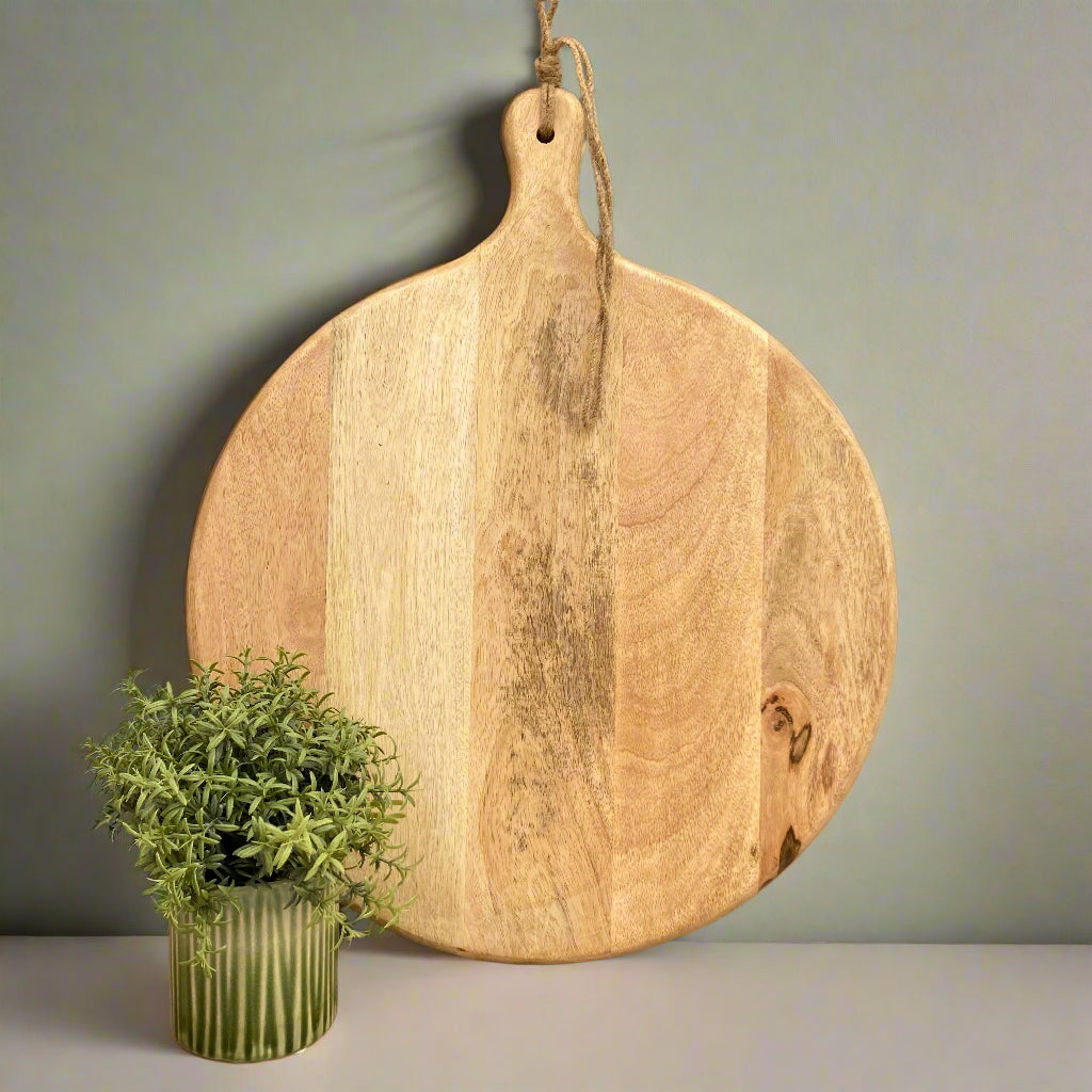 Large Mango wood chopping board on a green background