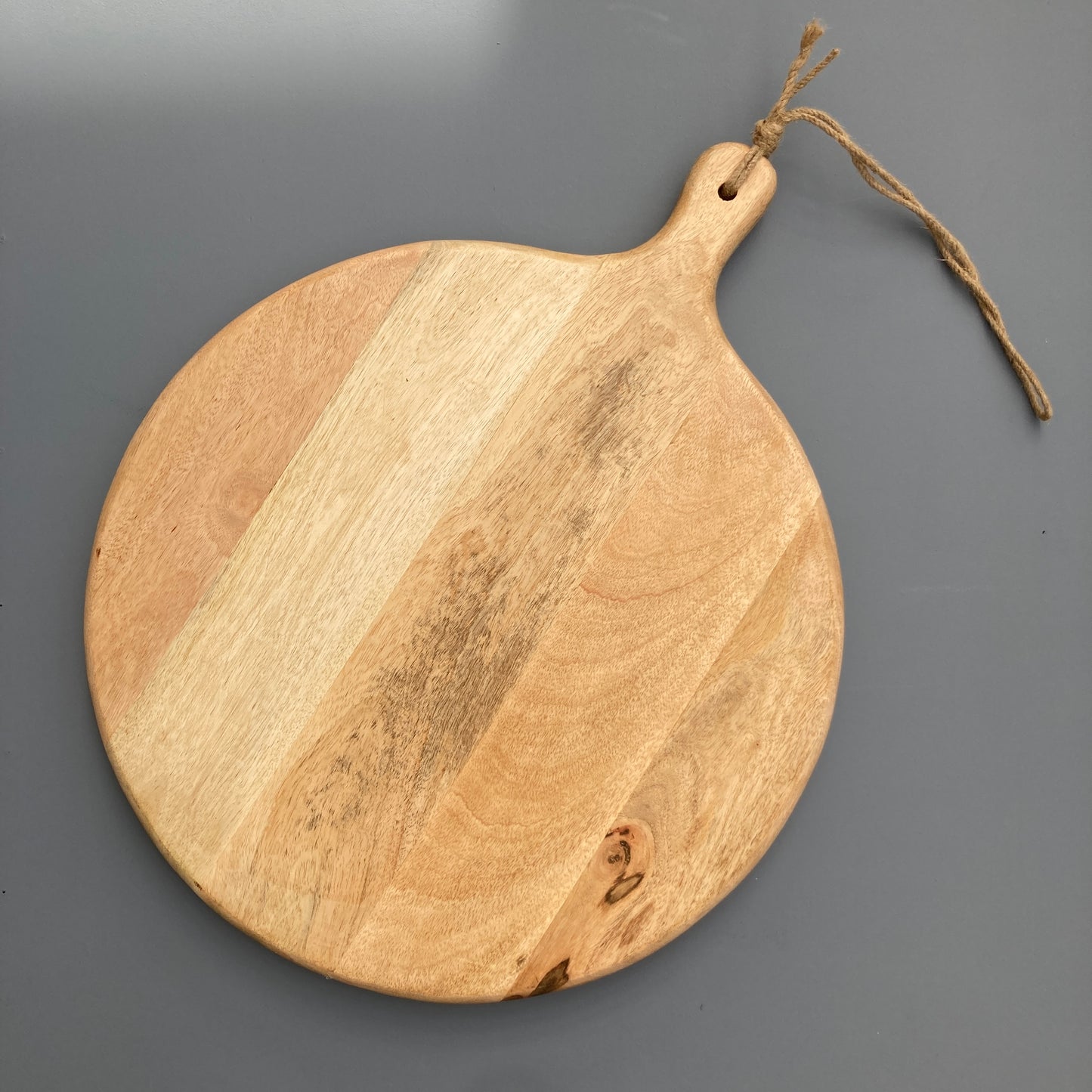 Large Mango wood chopping board on a grey background