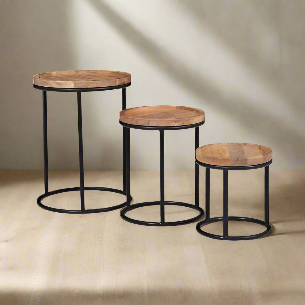 Industrial nest of 3 tables in a plain room setting