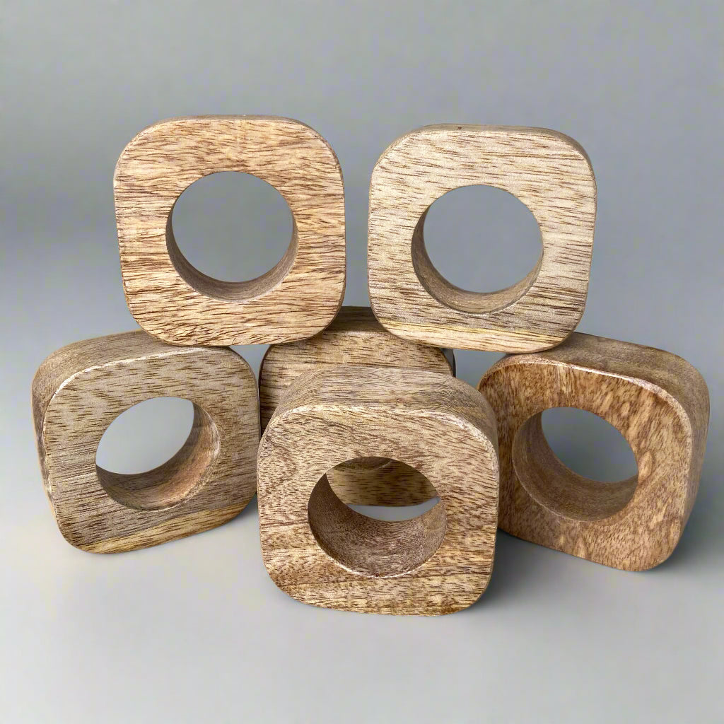 Set of solid Mango wood napkin rings. Multiple rings shown.