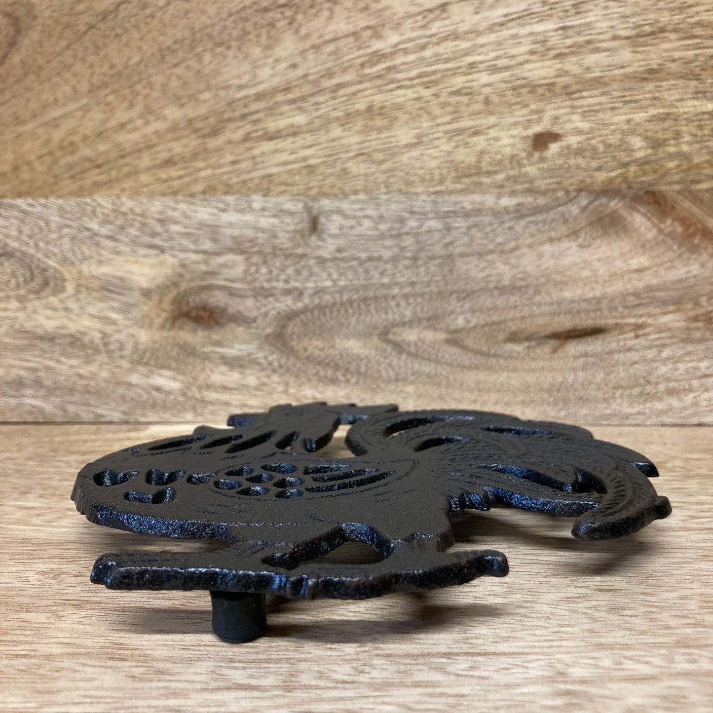 Black painted cast iron ROOSTER design trivet / hotplate - at an angle