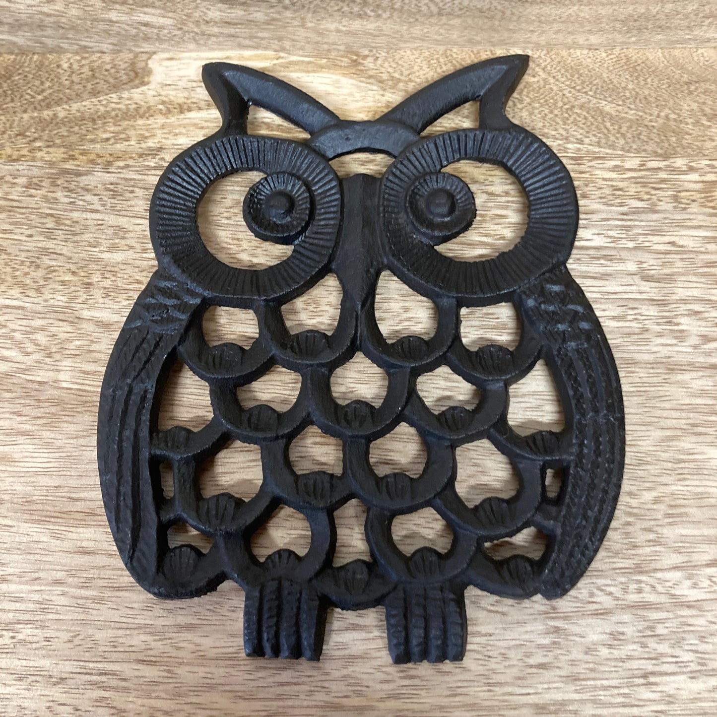 Black painted cast iron OWL design trivet / hotplate - on table