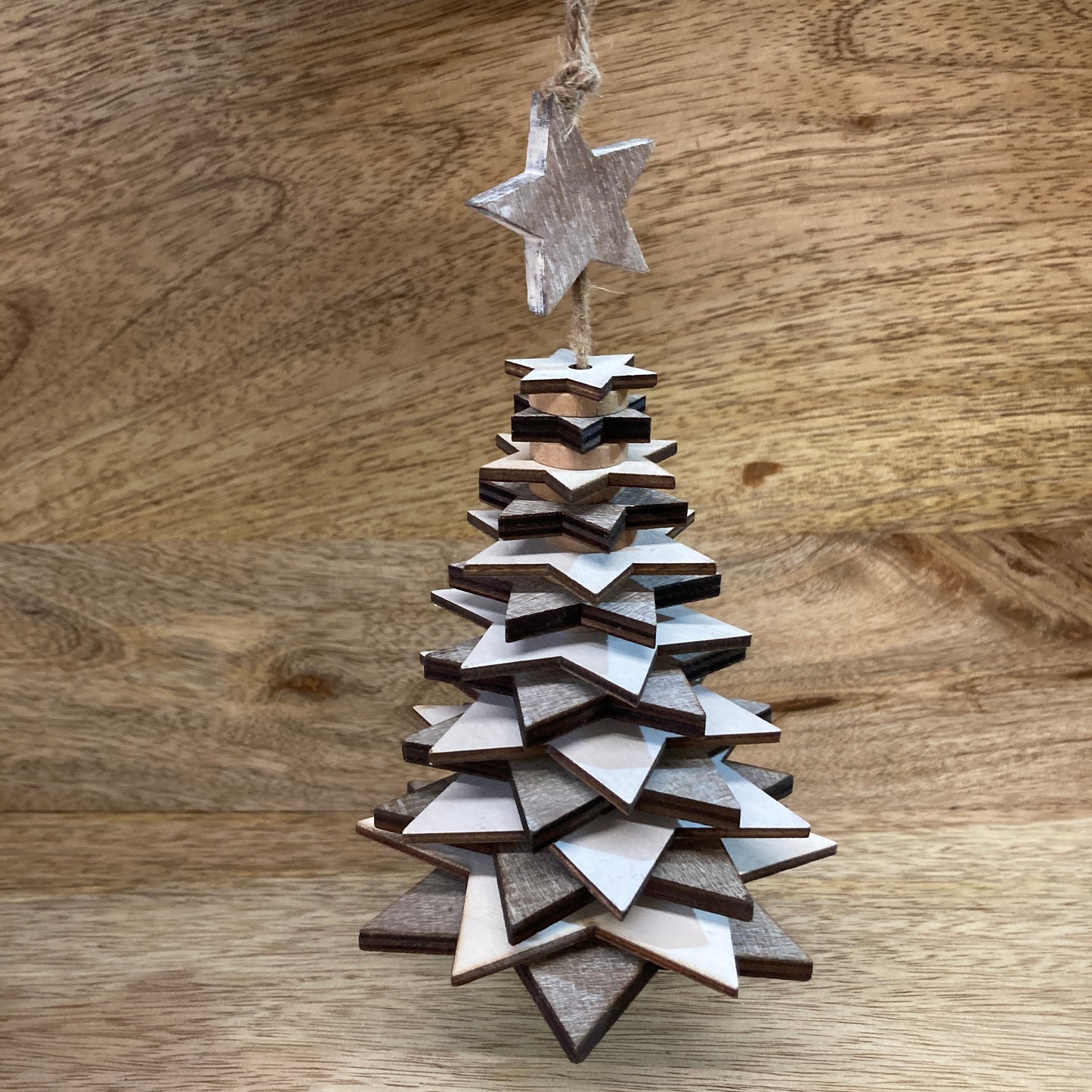 Wooden star Christmas trees on table.