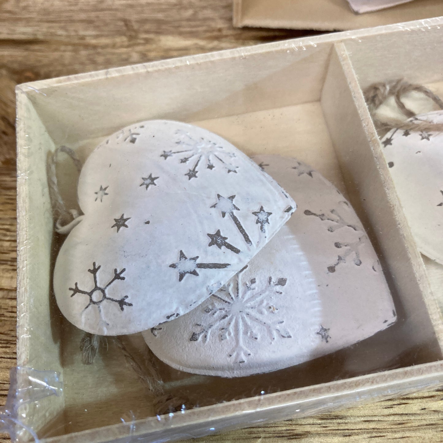2 hanging snowflake hearts in a box.