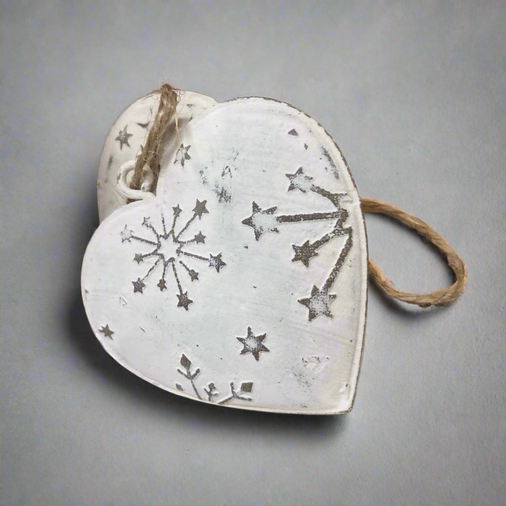 Pair of hanging snowflake hearts on display.