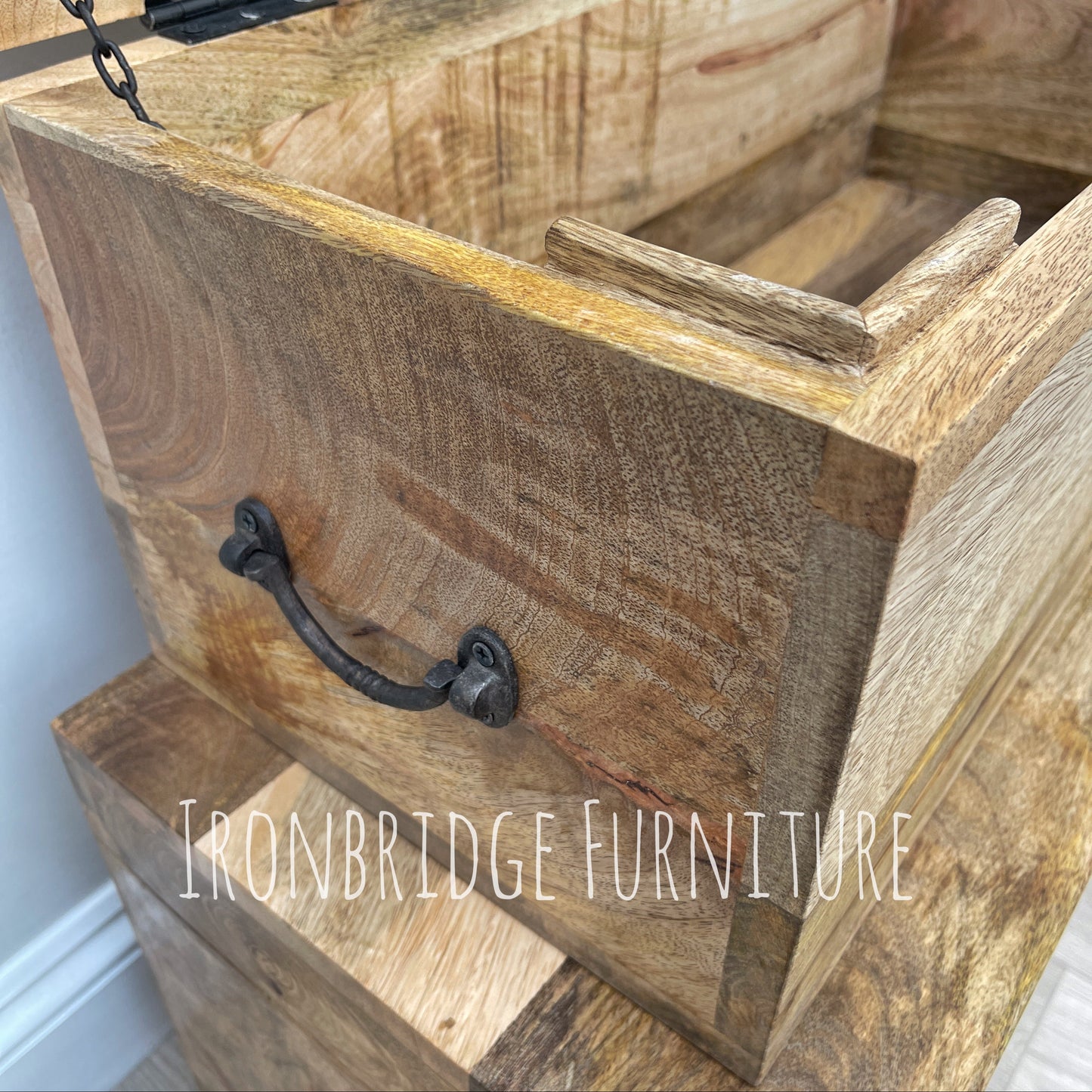 Wooden box with metal handle and 'Ironbridge Furniture' branding.