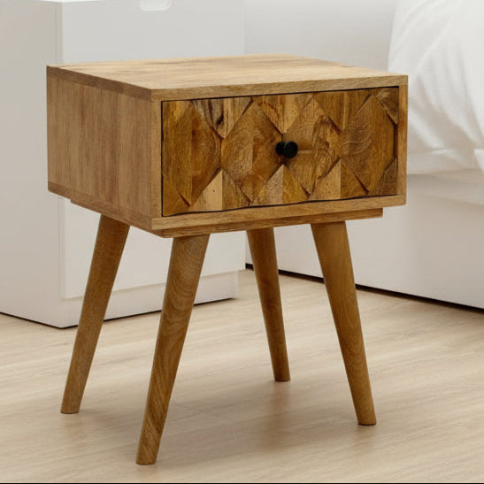 Wooden nightstand with geometric pattern on a light wooden floor.